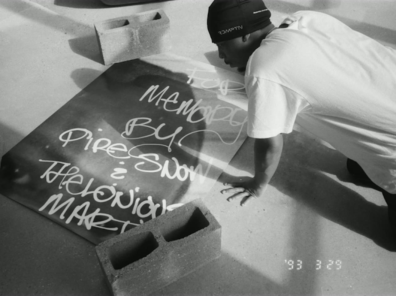 Laying out the For Memory poster between cinder blocks